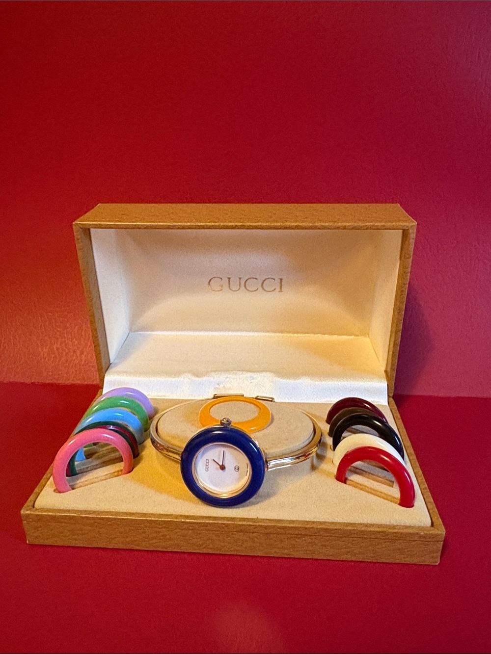 Gucci Women's Gold Tone Bangle Watch with Multicolor Interchangeable Bezels